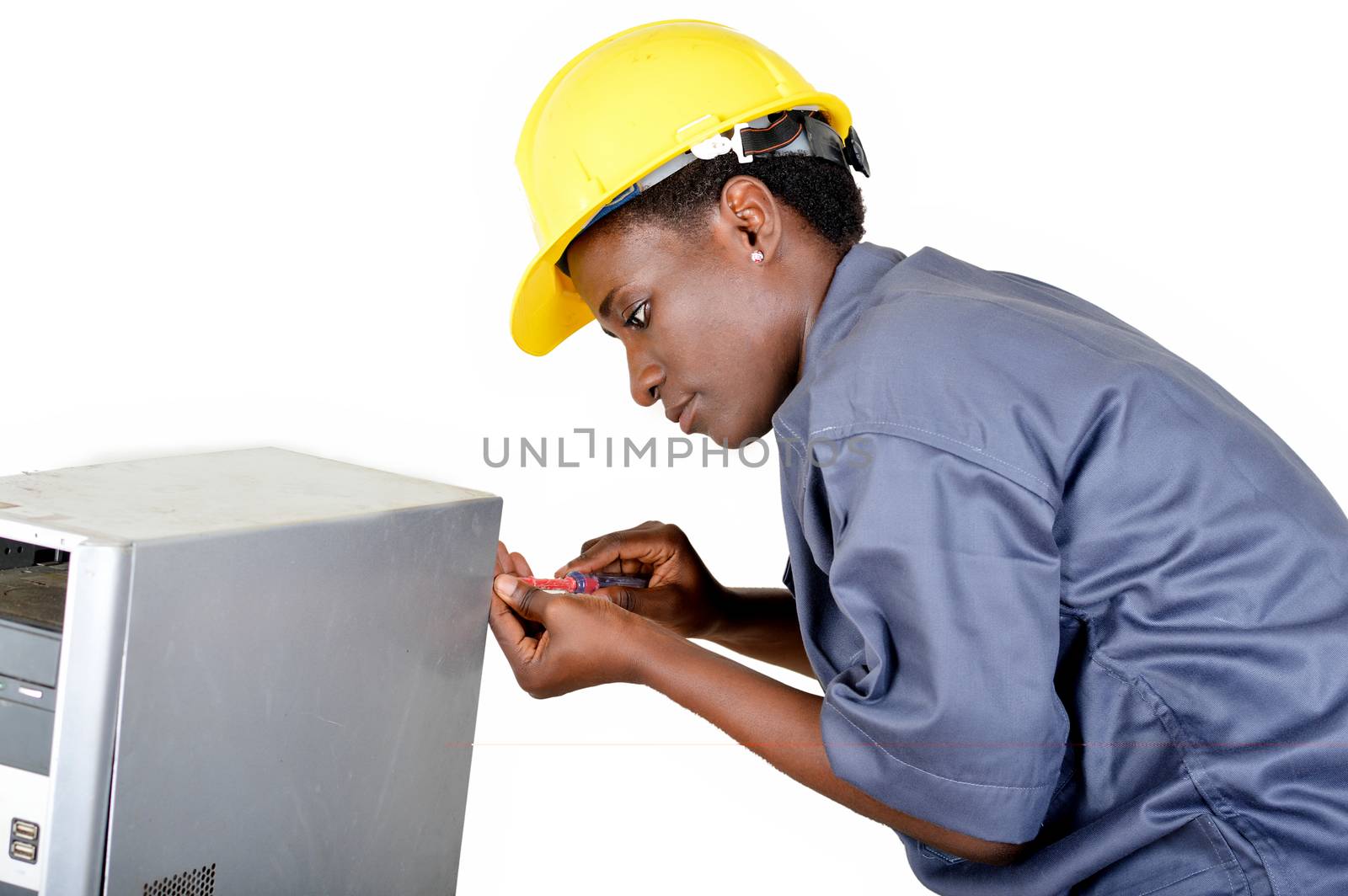 Young woman does the maintenance of a computer by disassembling it with a turn vice