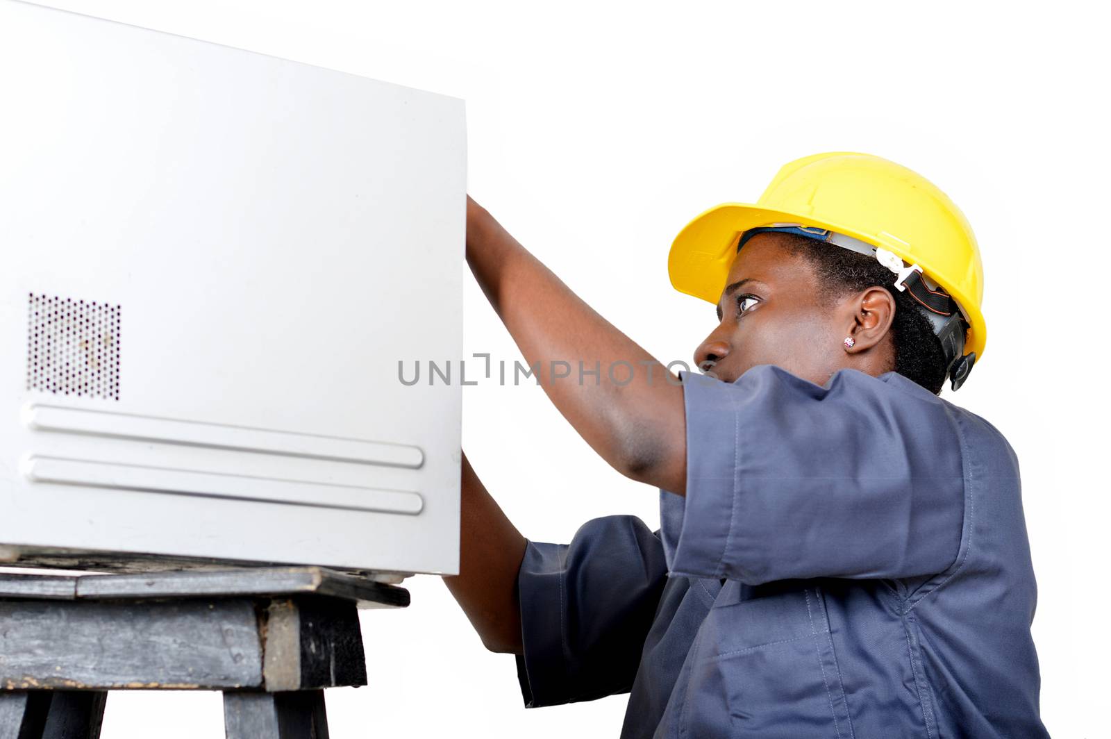 Close-up of a young woman doing the maintenance of a desktop computer.