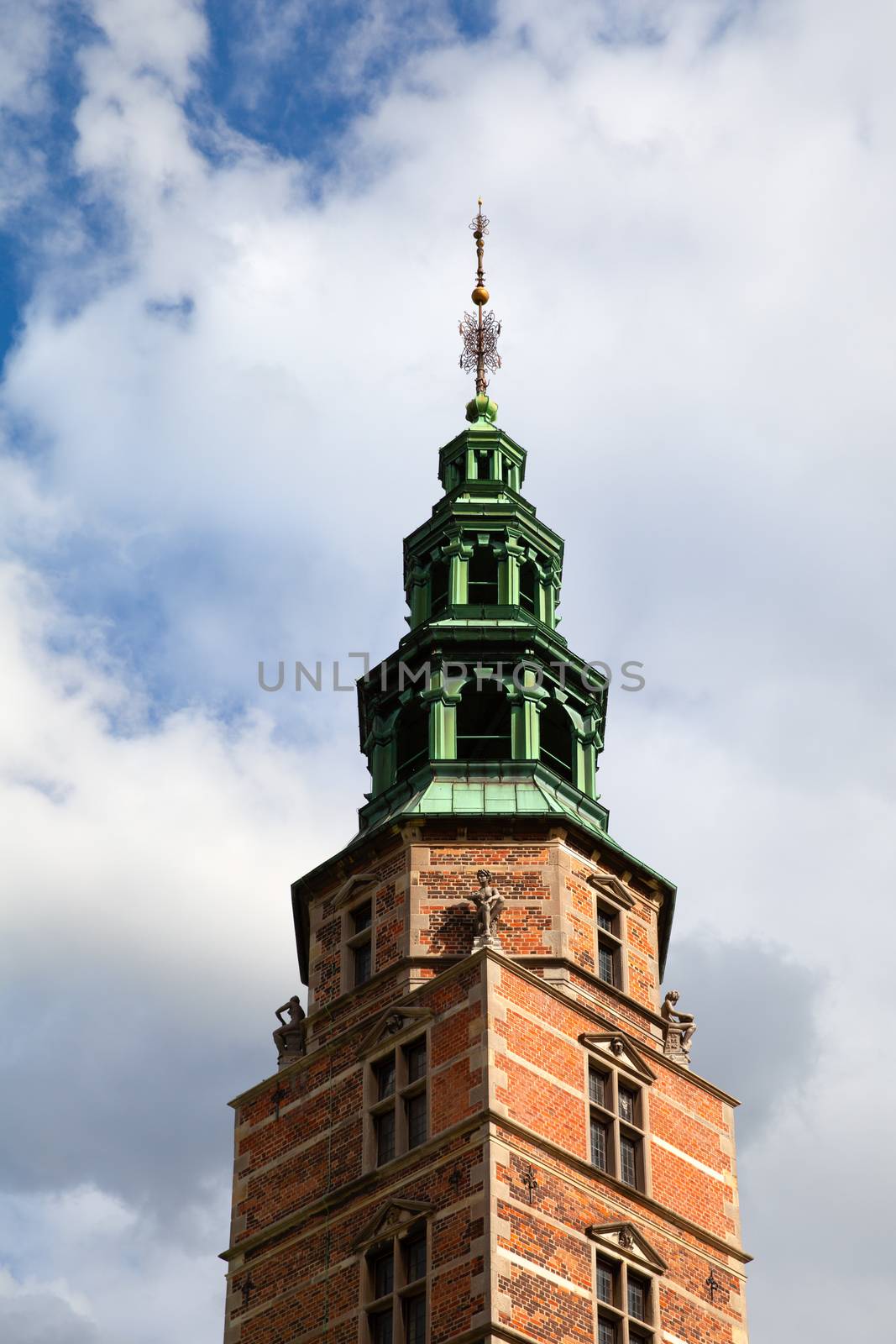 Copenhagen, Denmark - 12 September 2019: Tower of Rosenborg castle on a bright blue sky