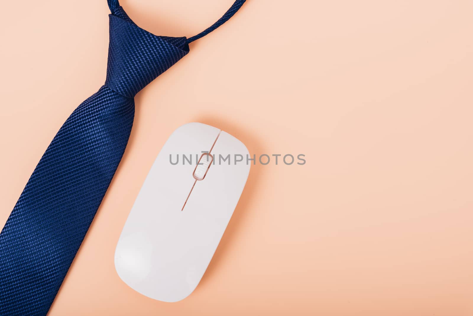 Top view business necktie and mouse on soft yellow desk table