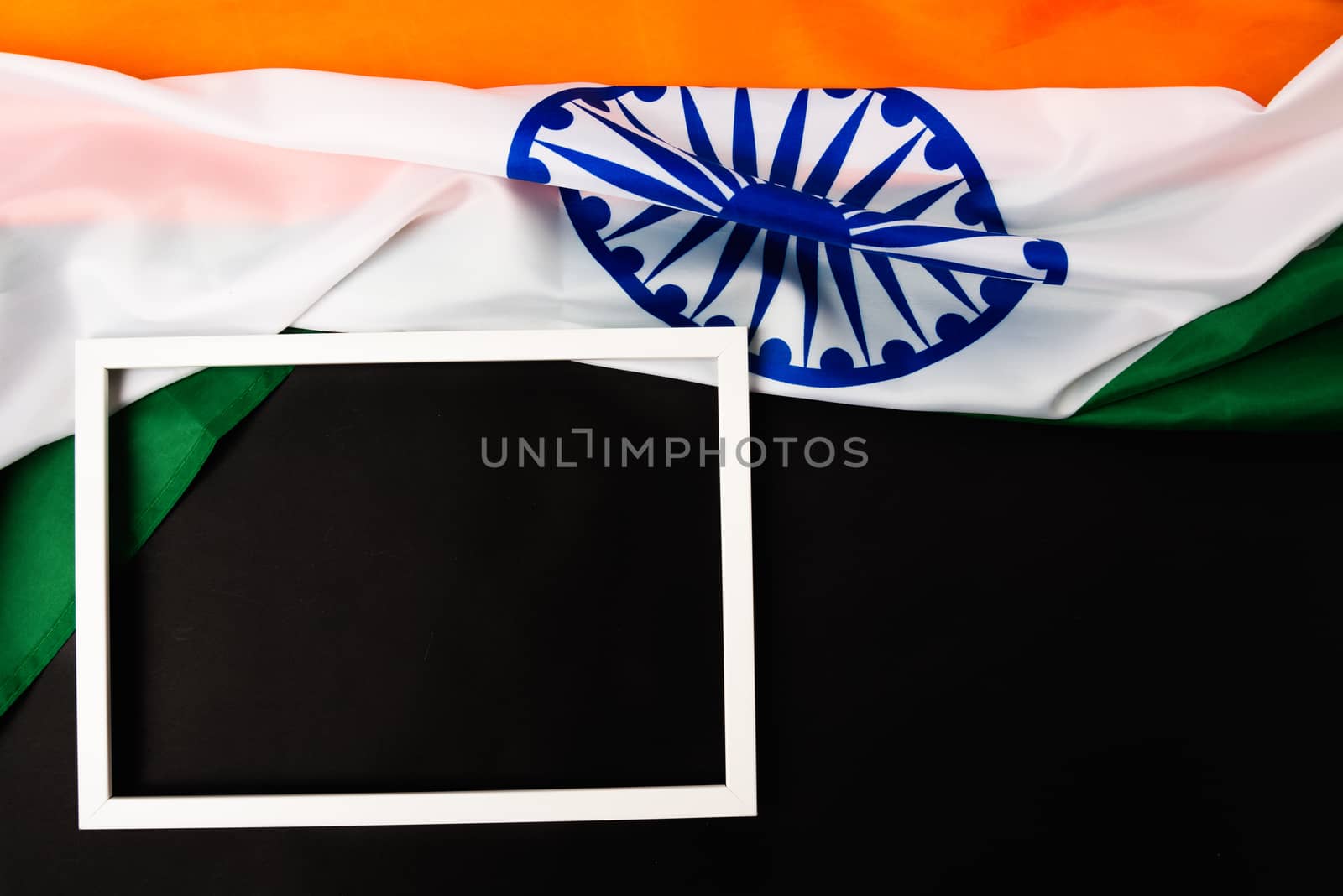 Indian republic day, flat lay top view, Indian flag and photo frame on black background with copy space for your text