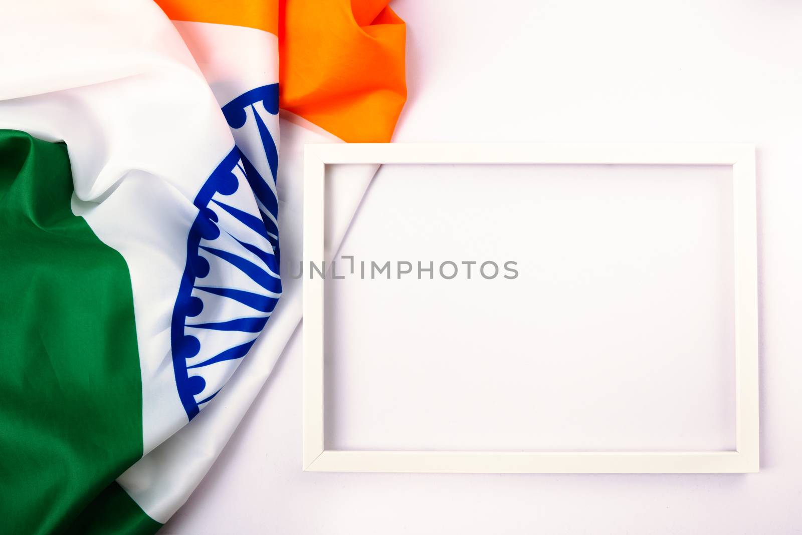 Indian republic day, flat lay top view, Indian tricolor flag and photo frame on white background with copy space for your text