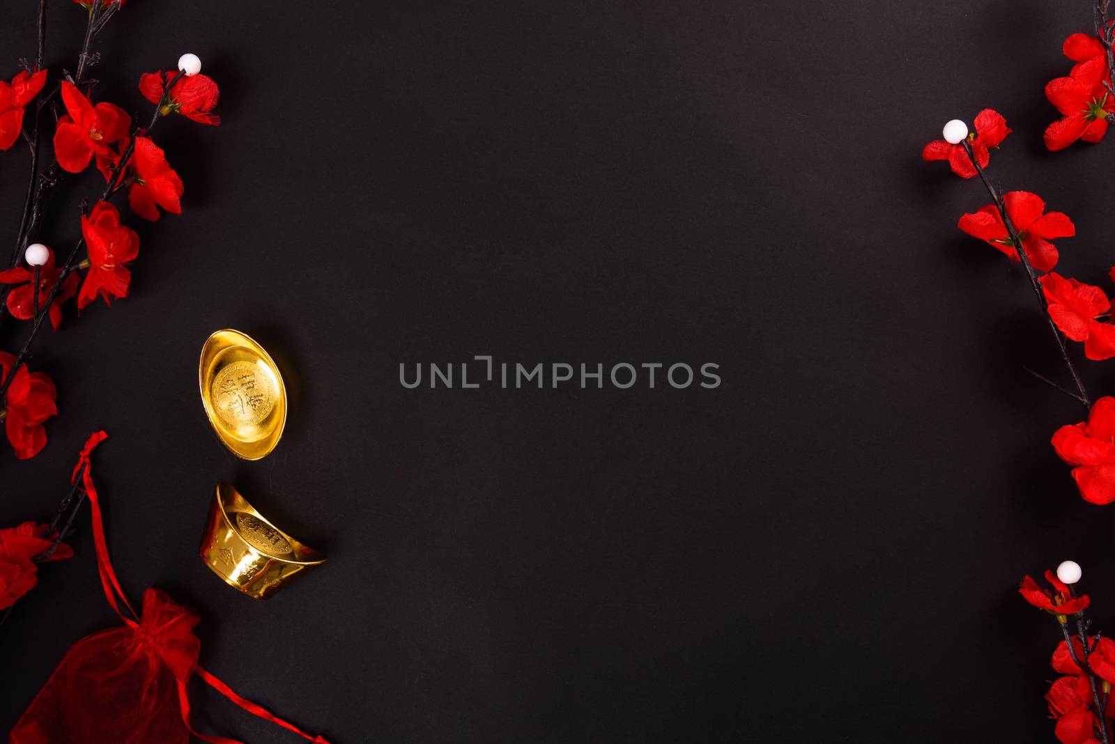 Chinese New Year, flat lay top view, gold bar and Chinese Flower on black background with copy space for your text