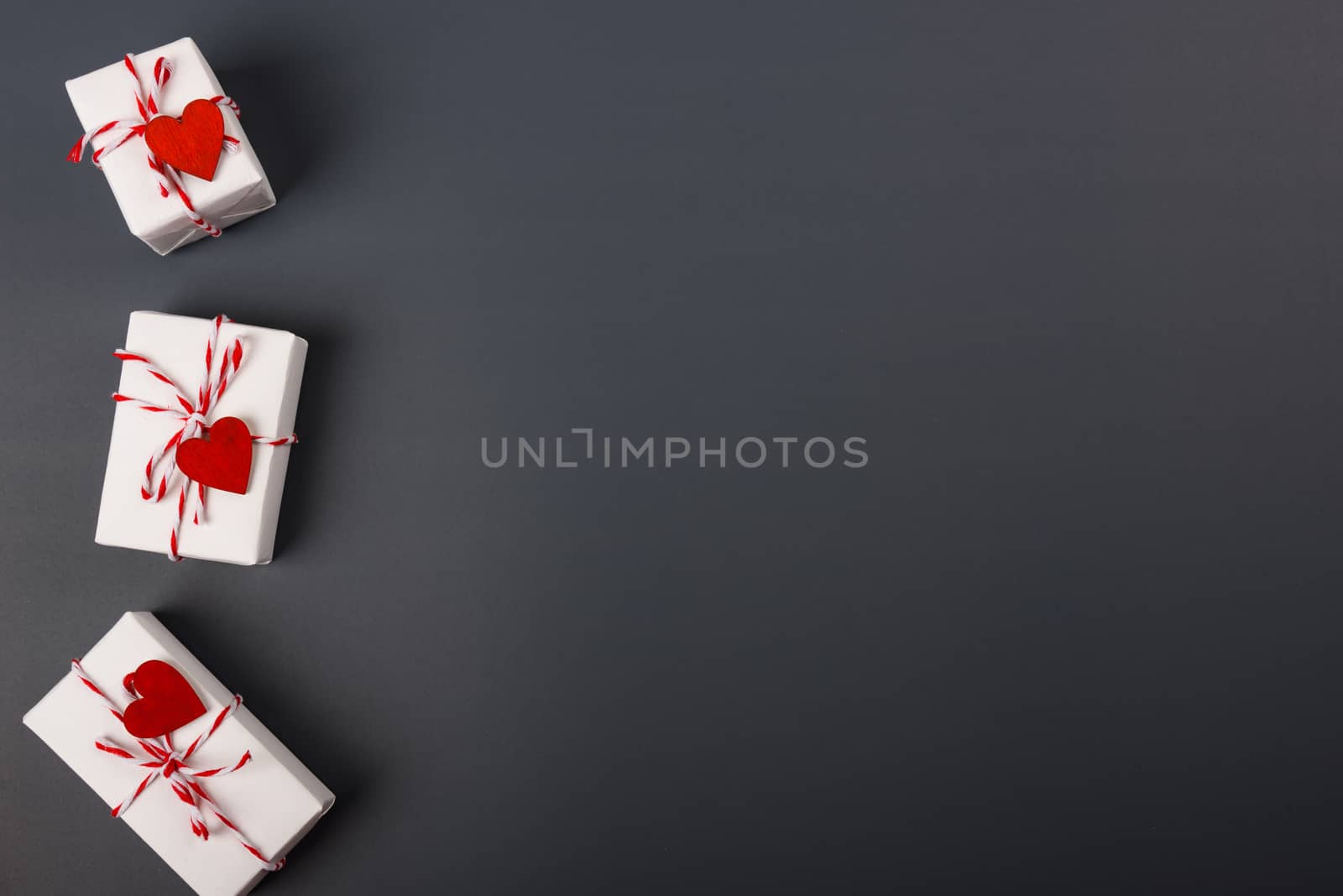 Valentine's day Concept, flat lay top view, White Gift Box and Red Heart on Gray background with copy space for your text