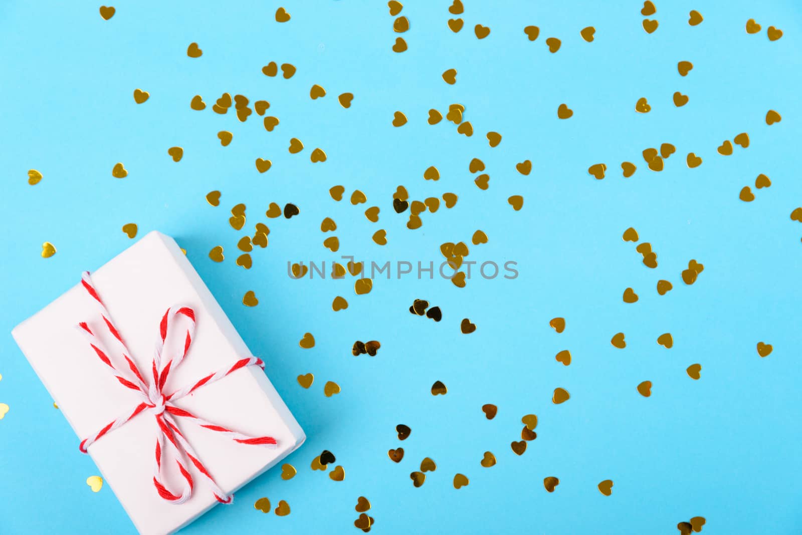 Valentine's day Concept, flat lay top view, White Gift Box and Red Heart on Blue background with copy space for your text