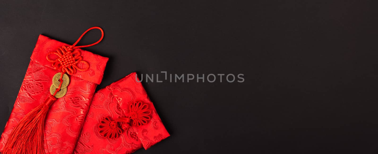 Chinese new year festival concept, flat lay top view, Happy Chinese new year with Red envelope (Character "FU" means fortune, blessing, wealth) on black background with copy space for your text