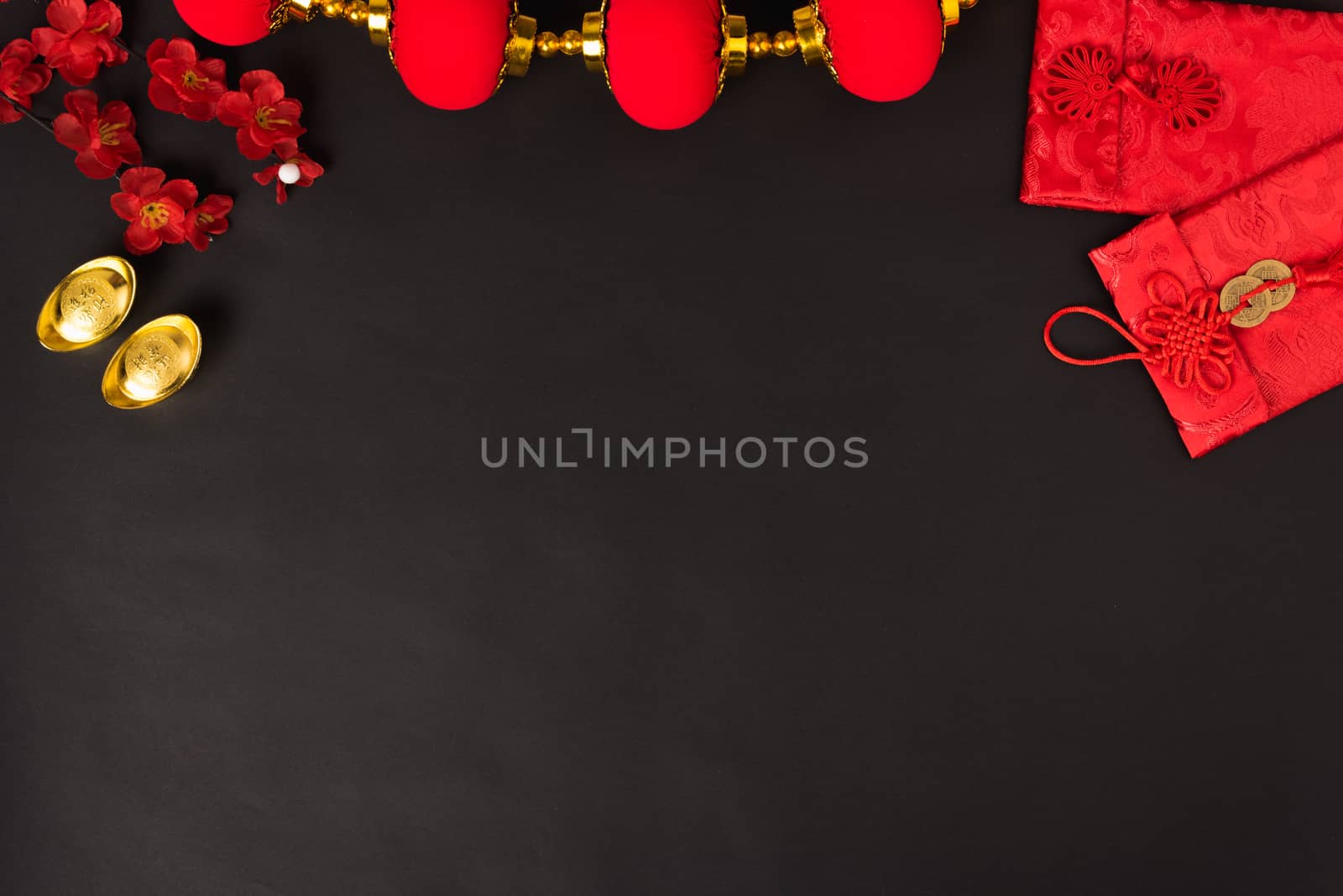Chinese new year concept, flat lay top view, Happy Chinese new year with Red envelope and gold ingot (Character "FU" means fortune, blessing, wealth) on black background with copy space for your text