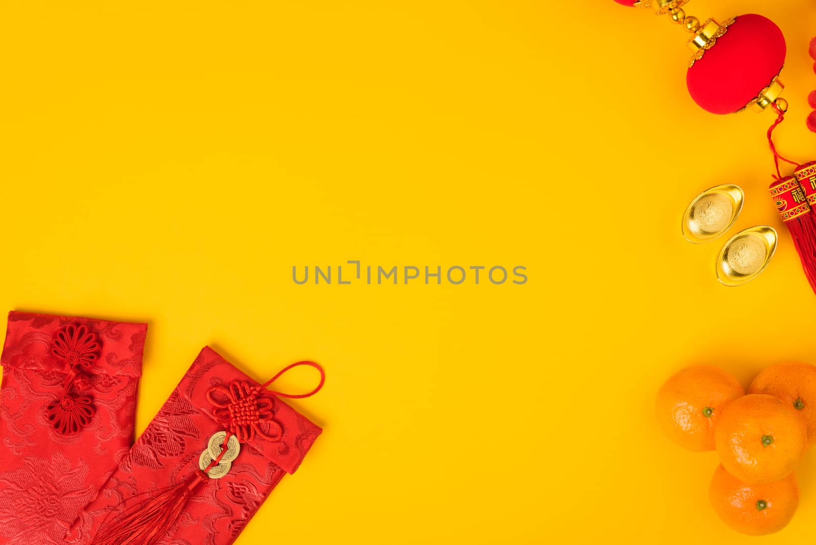 Chinese new year festival concept, flat lay top view, Happy Chinese new year with Red envelope and gold ingot (Character "FU" means fortune, blessing) on yellow background with copy space for text