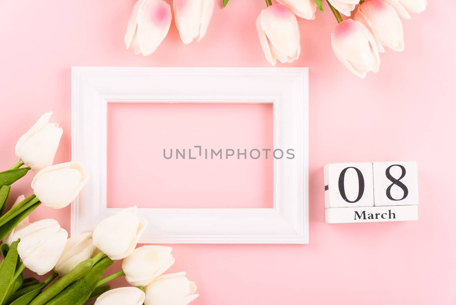 Happy Women's Day, Mother's Day concept. top view flat lay Tulip flower and photo frame on pink background, copy space for your text