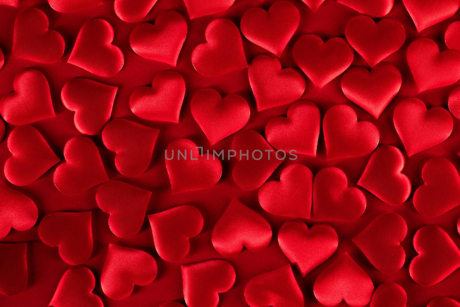 Valentine's day many red silk hearts background, love concept