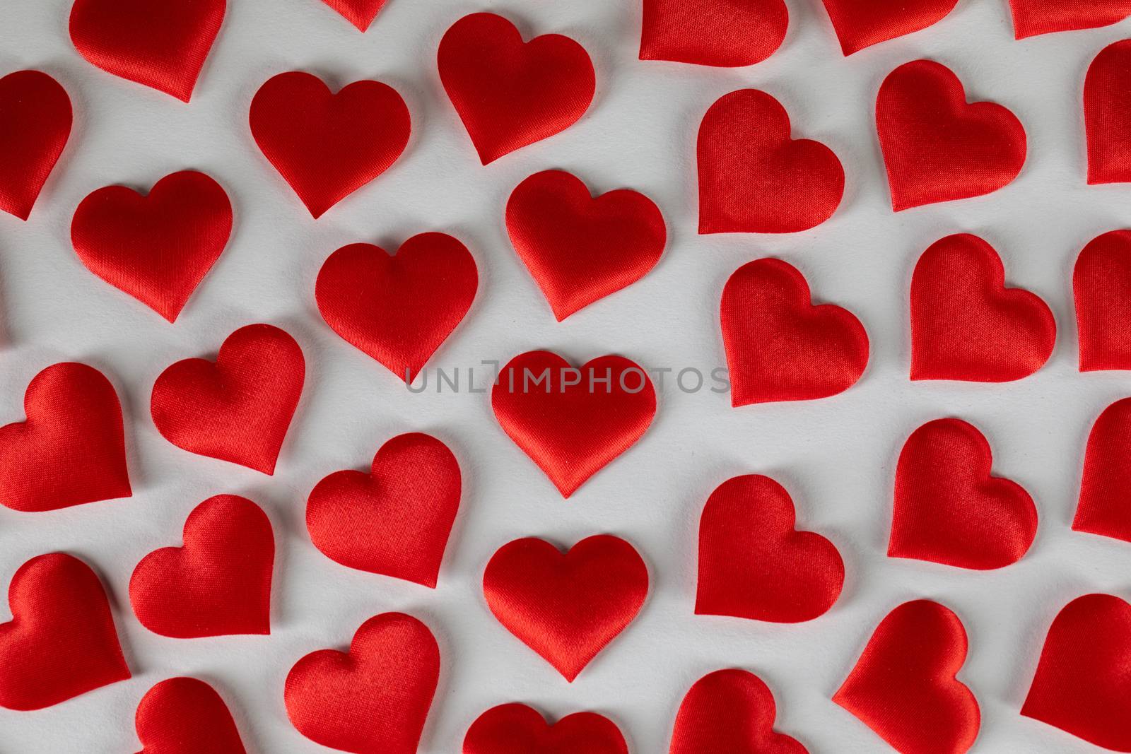 Valentine's day many red silk hearts on white background, love concept