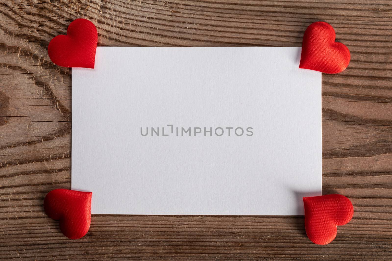 Valentine's day white blank paper greeting card and red silk hearts, background border frame with copy space, love concept