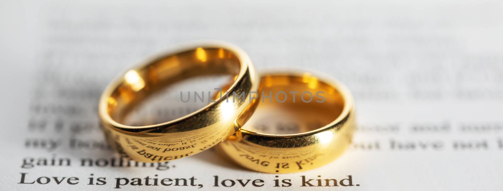 Golden wedding rings on bible book by Yellowj