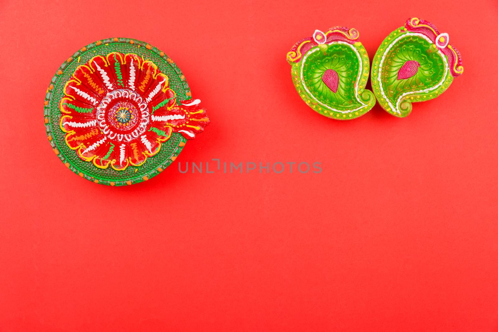 Happy Diwali Day, Flat lay top view Colorful Clay Diya lamps on red background and copy space for your text