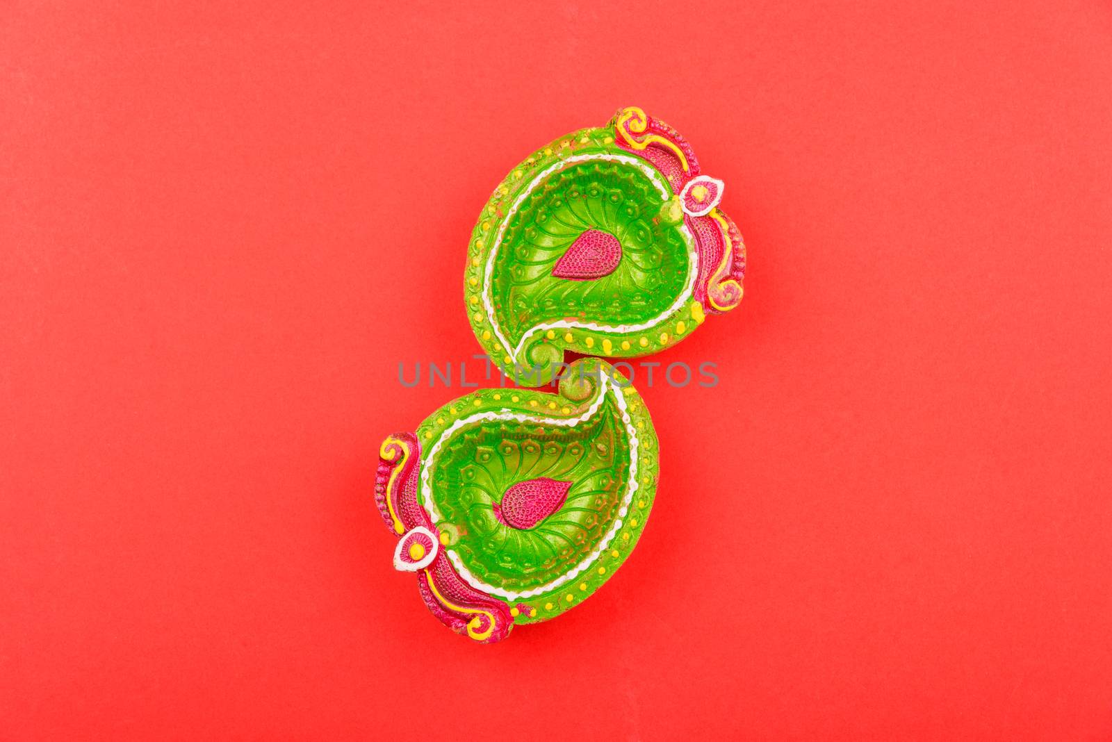 Happy Diwali Day, Flat lay top view Colorful Clay Diya lamps on red background and copy space for your text