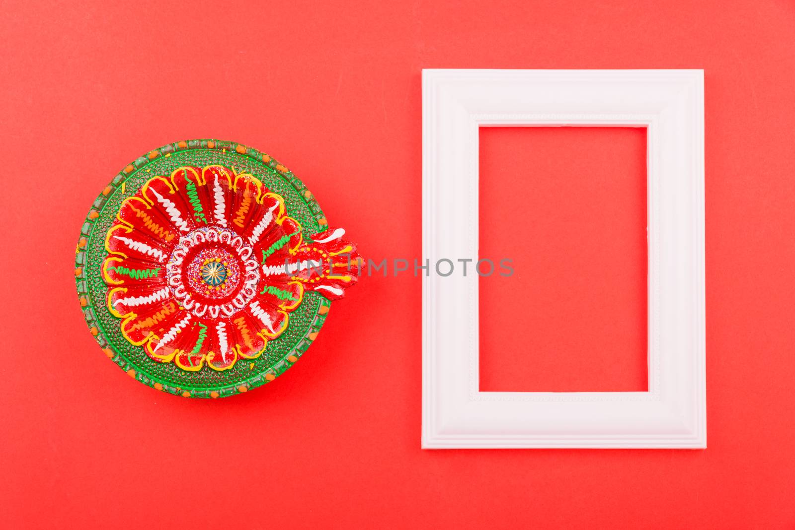 Happy Diwali Day, Flat lay top view Colorful Clay Diya lamps and photo frame on red background and copy space for your text