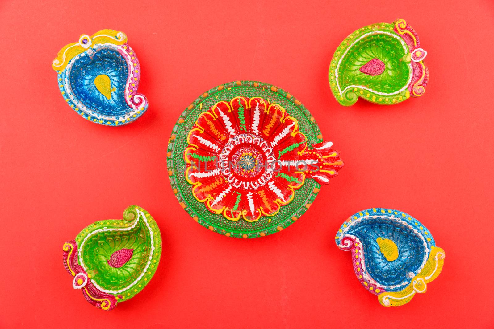 Happy Diwali Day, Flat lay top view Colorful Clay Diya lamps on red background and copy space for your text