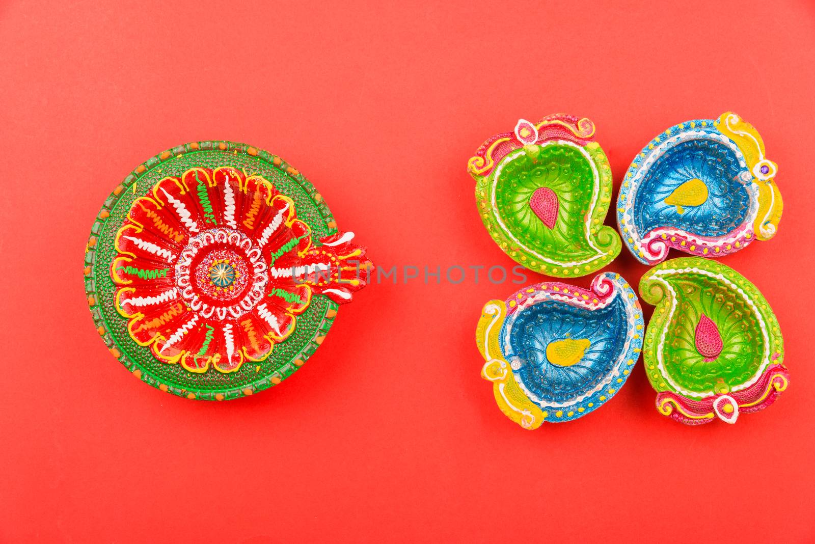 Happy Diwali Day, Flat lay top view Colorful Clay Diya lamps on red background and copy space for your text