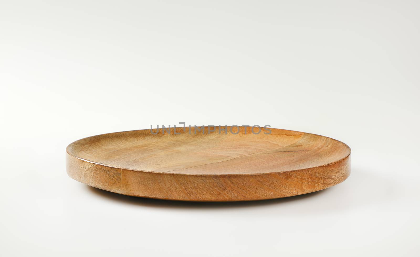 Empty round wooden platter for serving cheese, fruit and other food