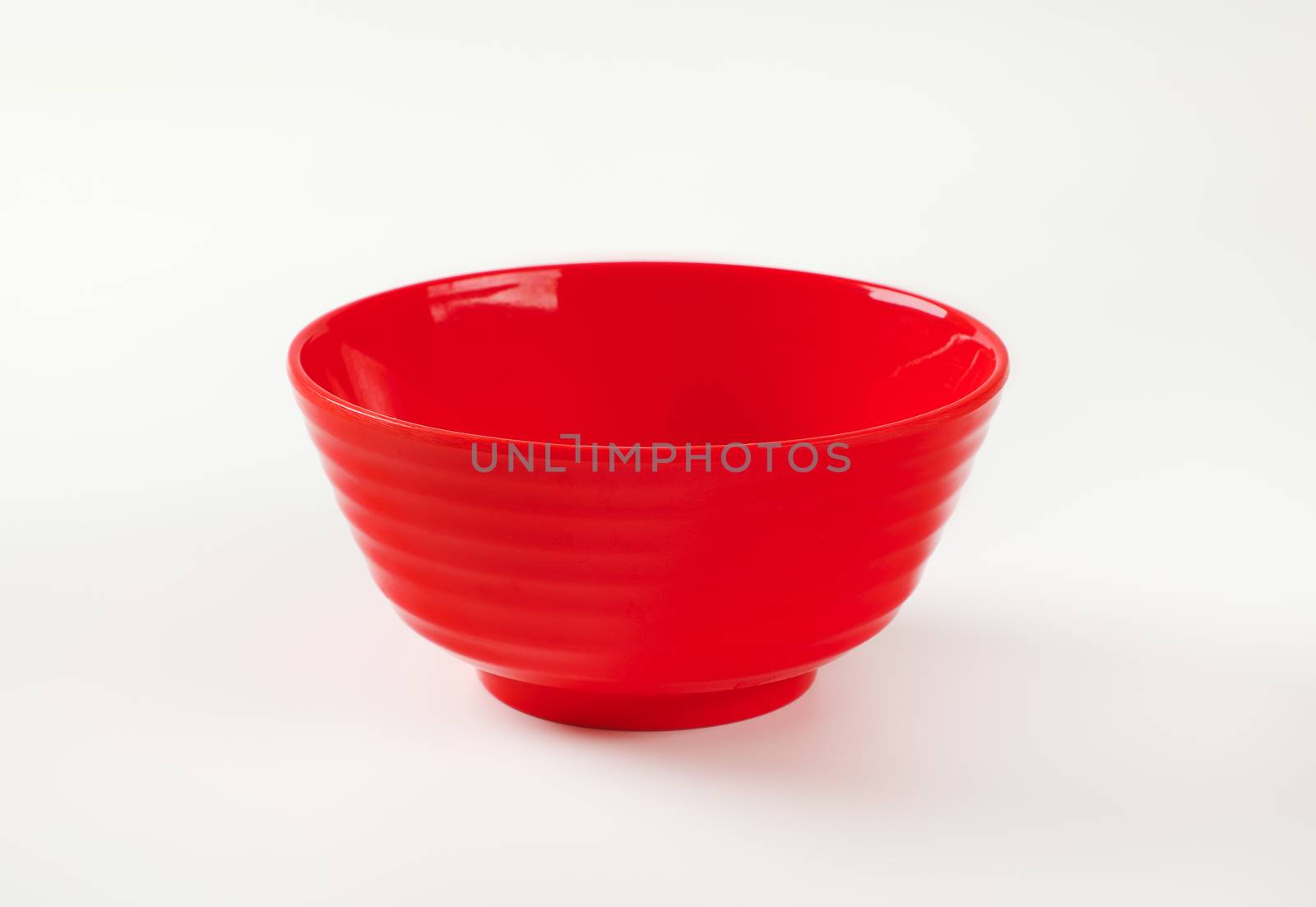Empty deep red plastic bowl