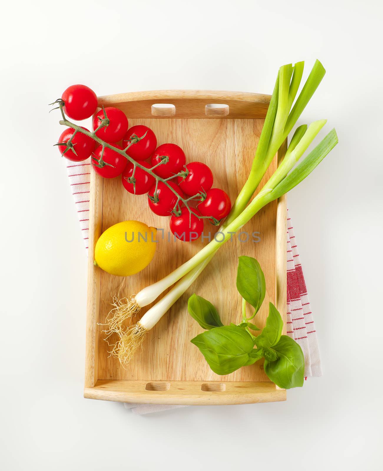 Wooden serving tray wit fresh vegetables and fruit by Digifoodstock