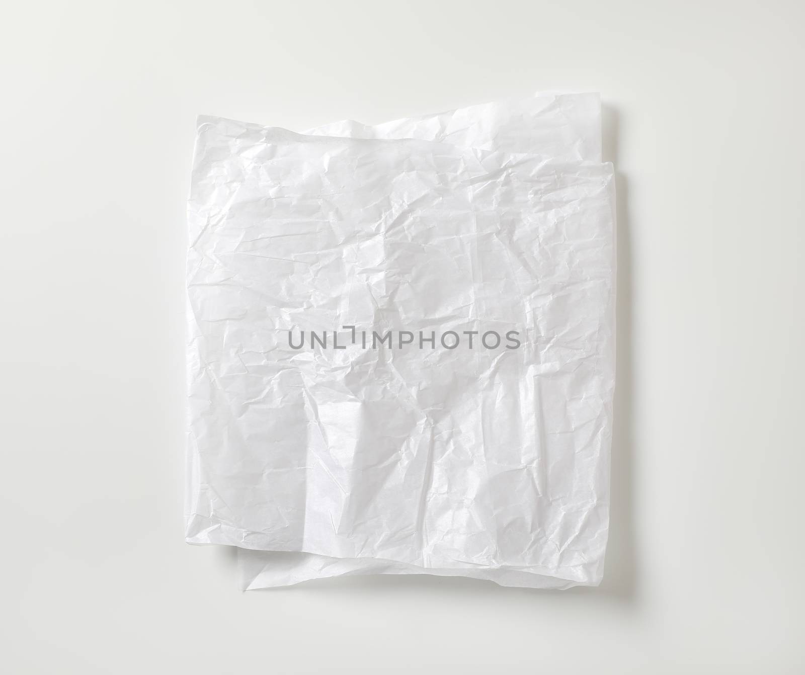 Crumpled white waxed packing paper by Digifoodstock