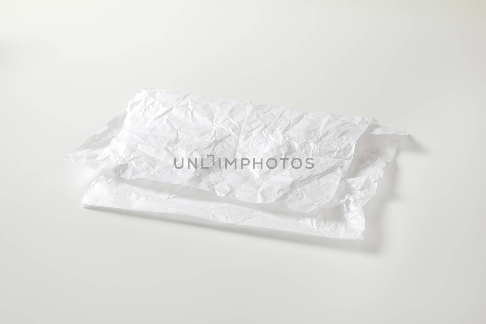 Crumpled white waxed packing paper by Digifoodstock