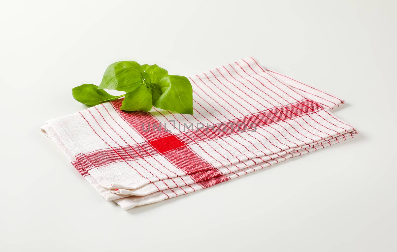 Striped tea towel an fresh basil leaves