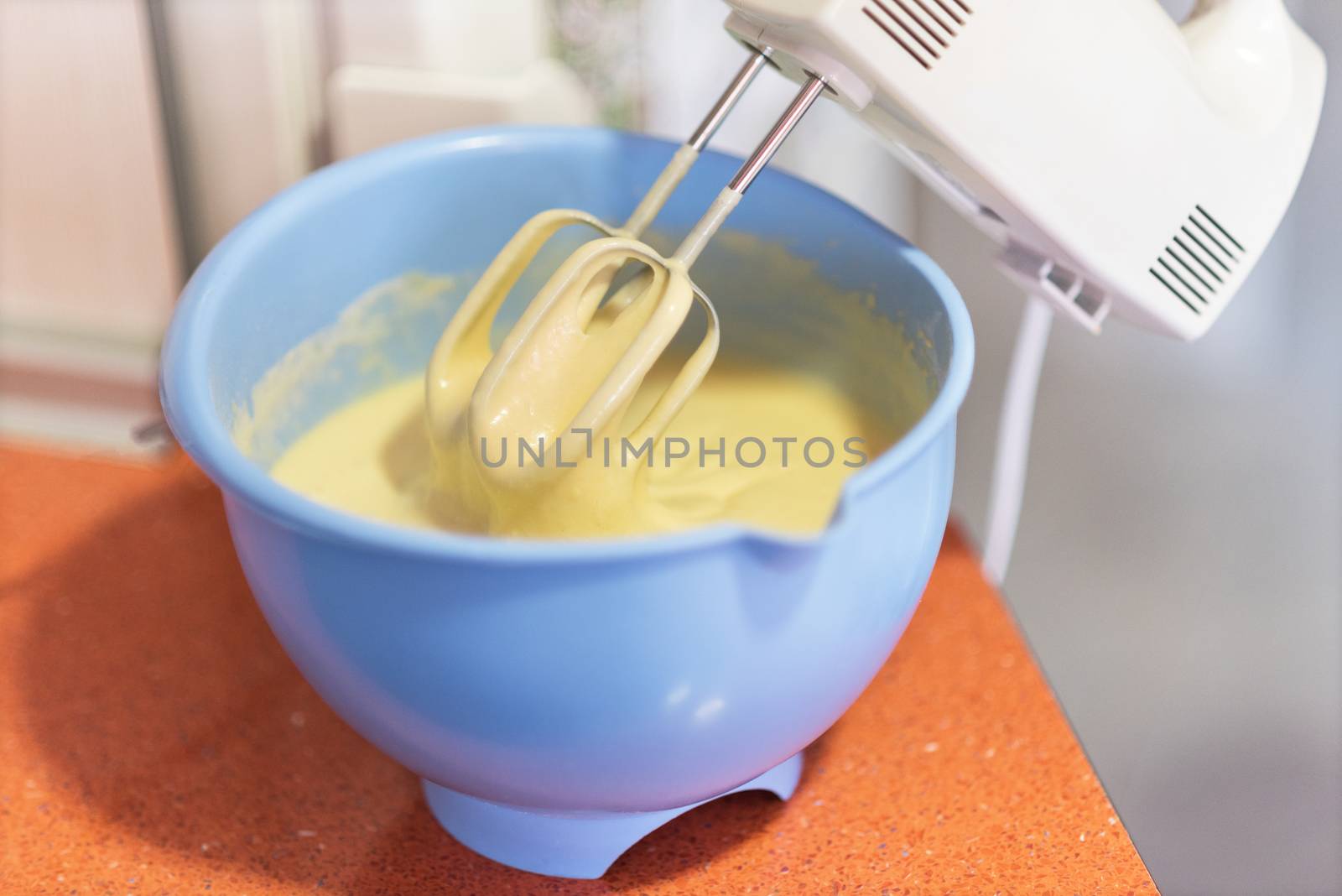 close up mixing biscuit dough with a electric mixer. Shallow deep of field by HERRAEZ