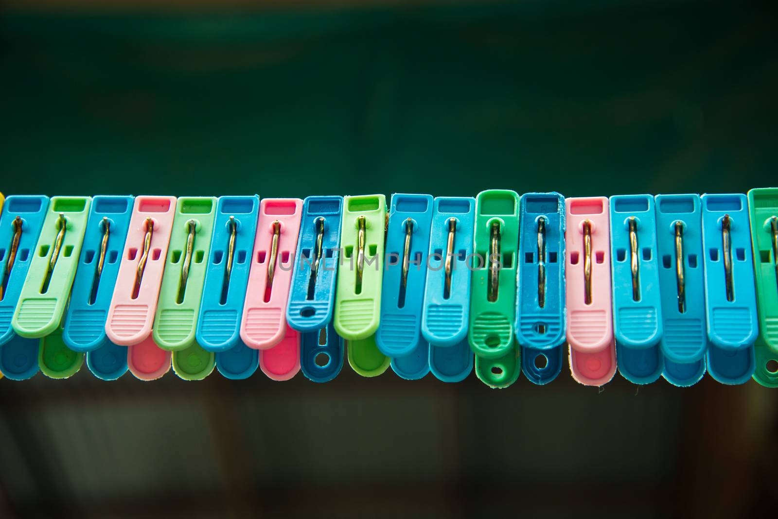 Clothes peg hang on a cord.