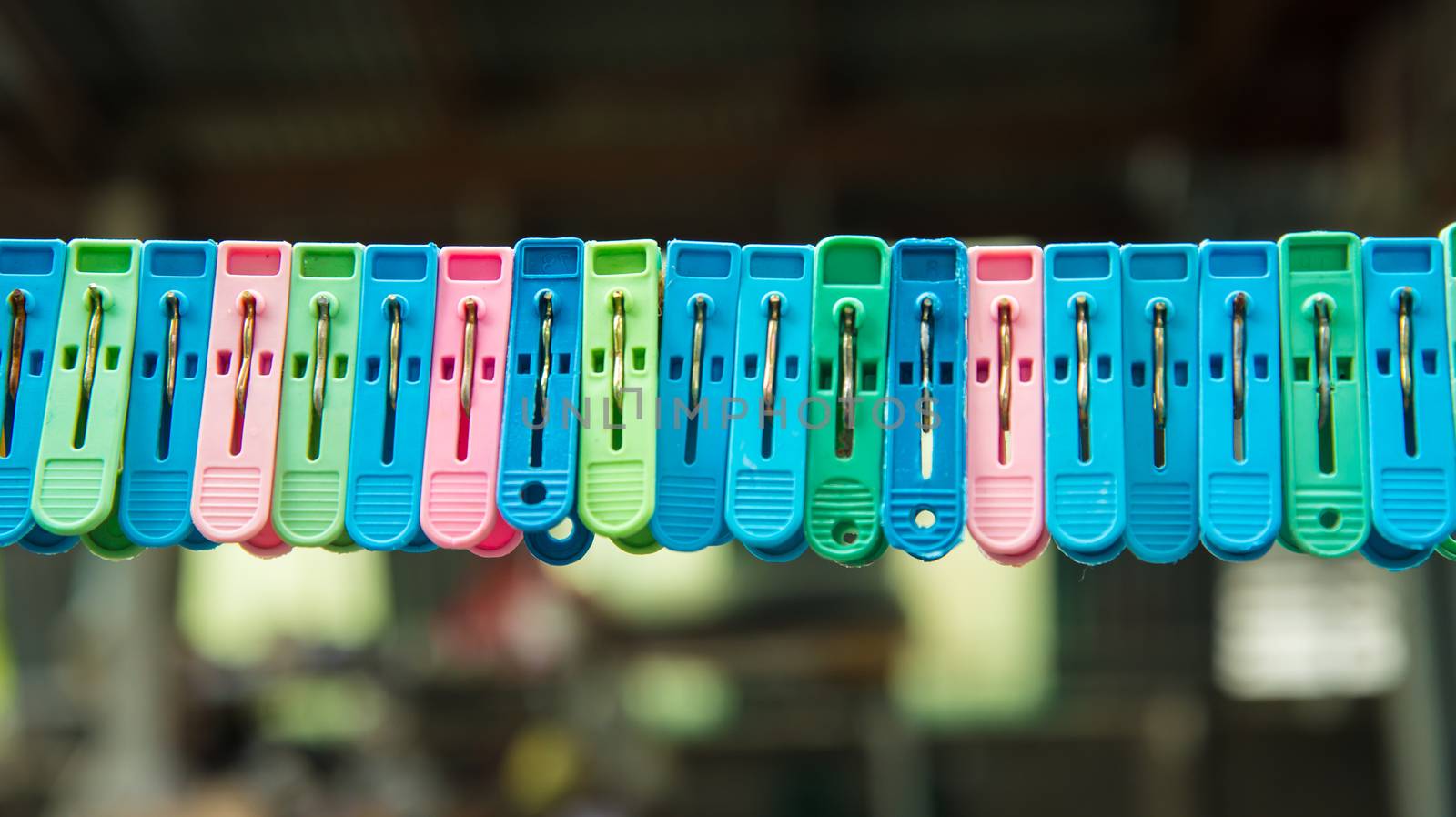 Clothes peg hang on a cord.
