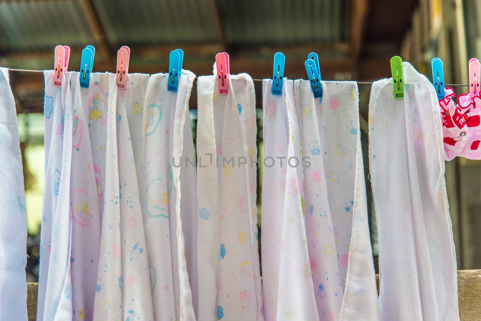 Diaper hanging on a clothes line.