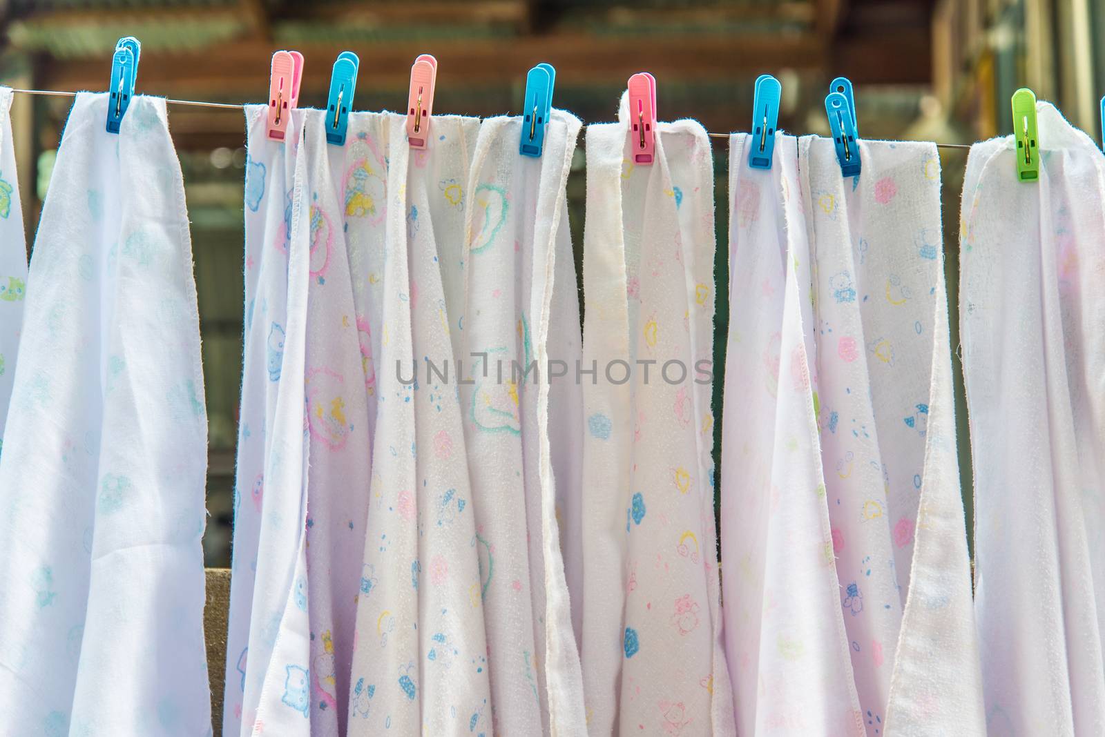 Diaper hanging on a clothes line.