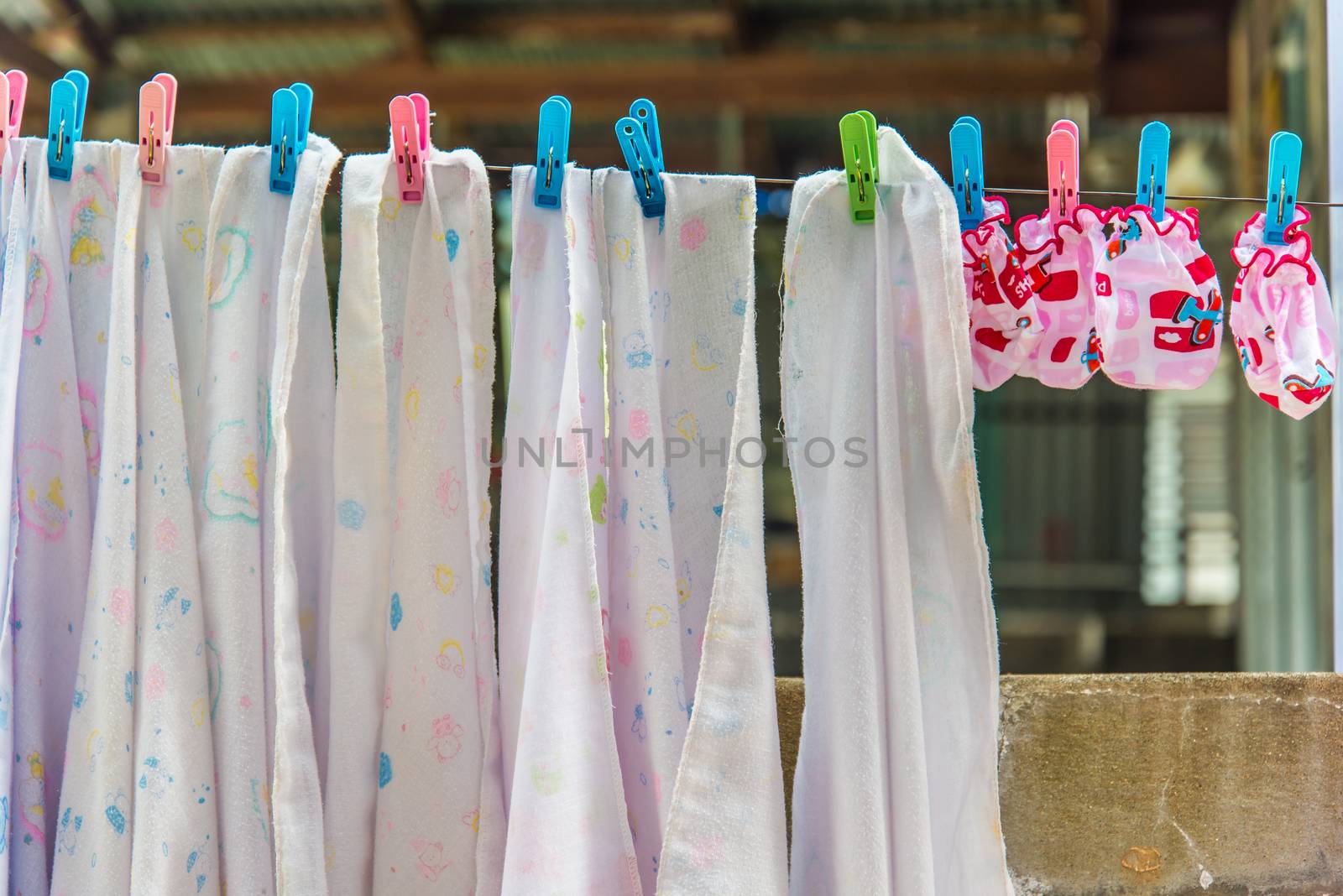 Diaper hanging on a clothes line.