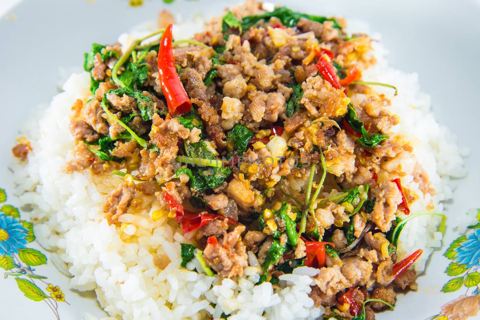 Fried pork and basil on white background.