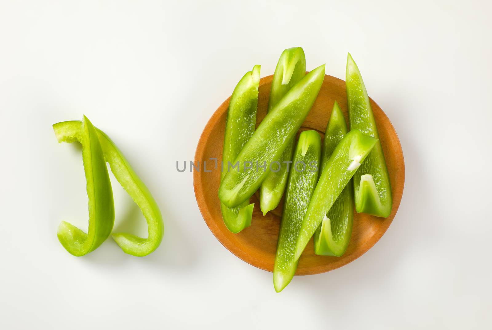 Slices of fresh green bell pepper on plate
