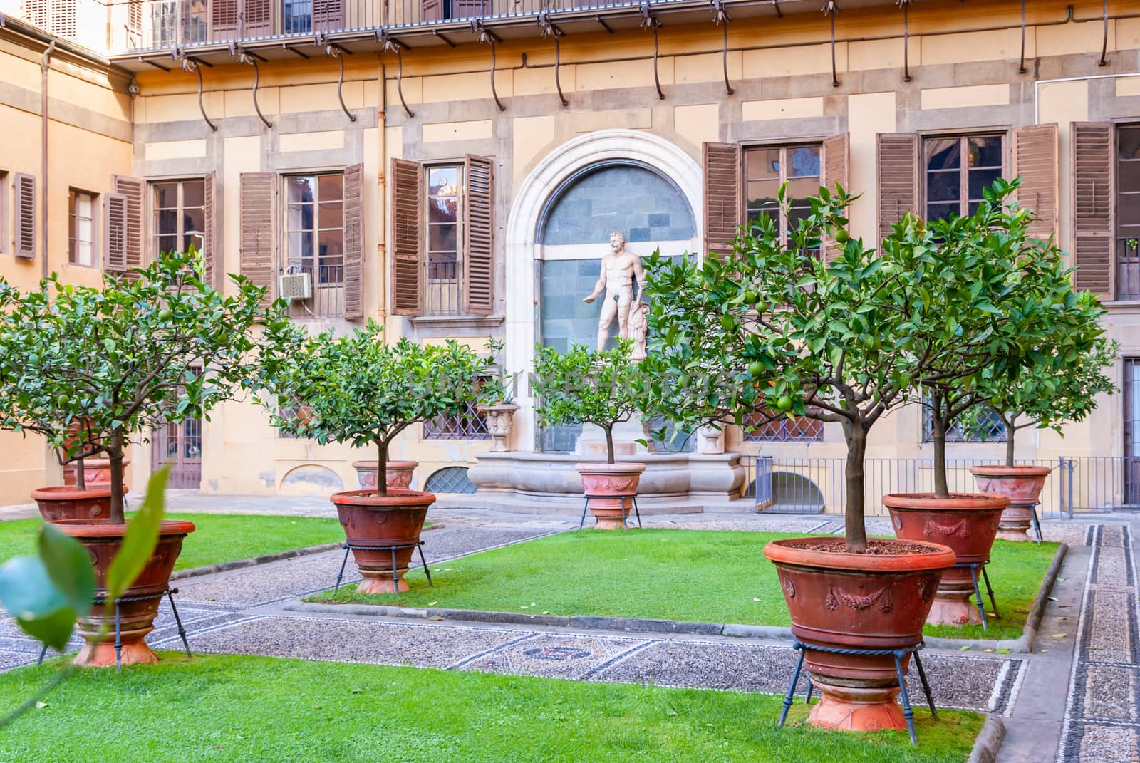 Outer courtyard of the Medici Riccardi Palace, which has an Italian garden with statues and tubs with plants. Florence, Italy