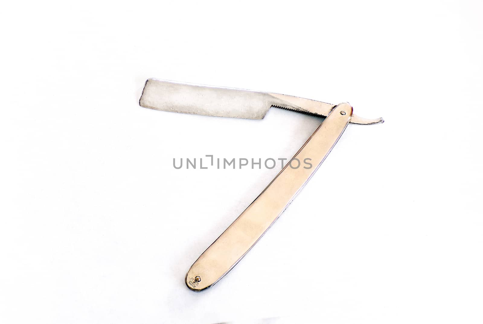A manual or dangerous razor is isolated on a white background. Polished razor with chrome. Razor in retro style.