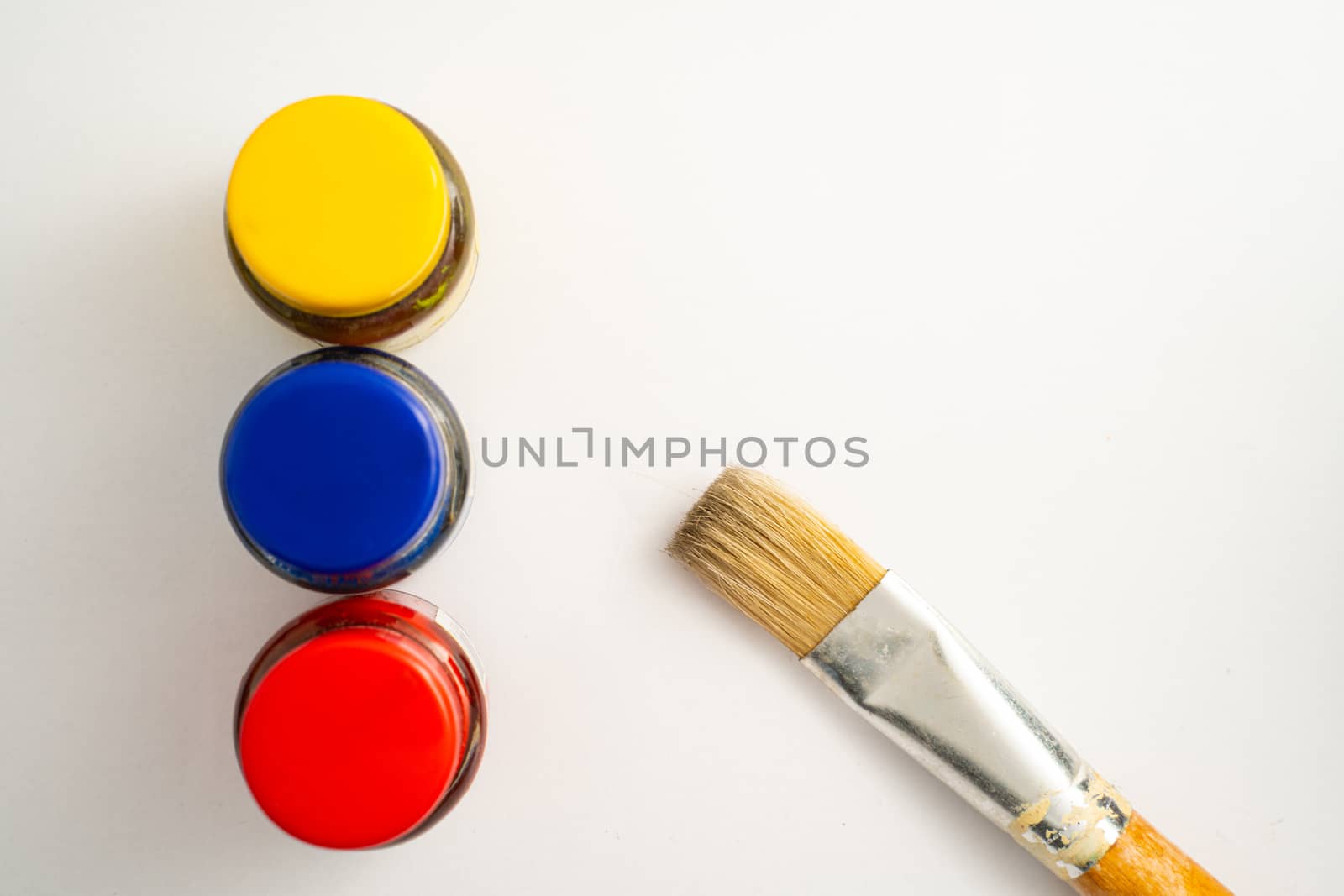 The Top view of bottles of primary color on white background.