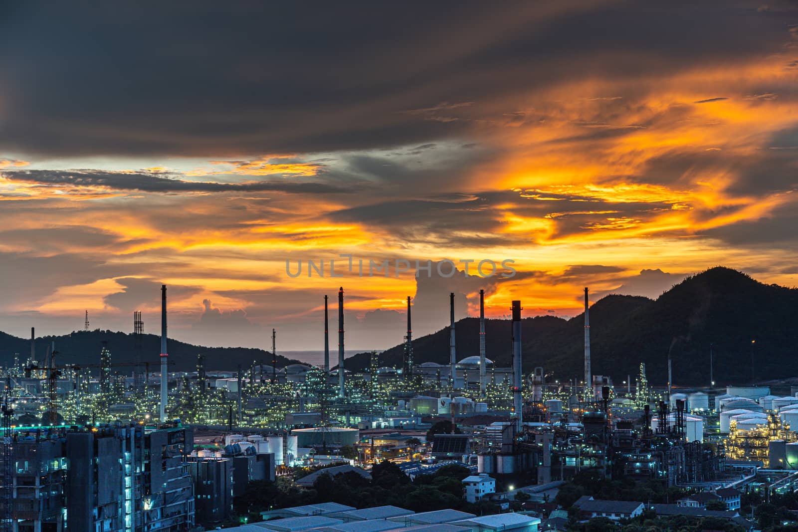 The Oil refinery and petrochemical plants Steel pipe equipment at sunrise background