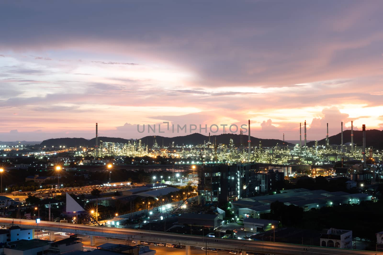 Oil refinery and petrochemical plants Steel pipe equipment at sunrise background by peerapixs