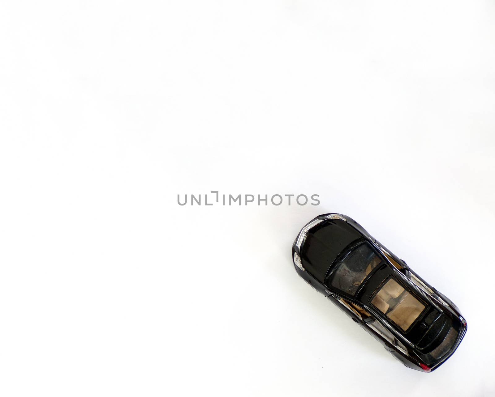 Black metal car model on white background top view with copy space.