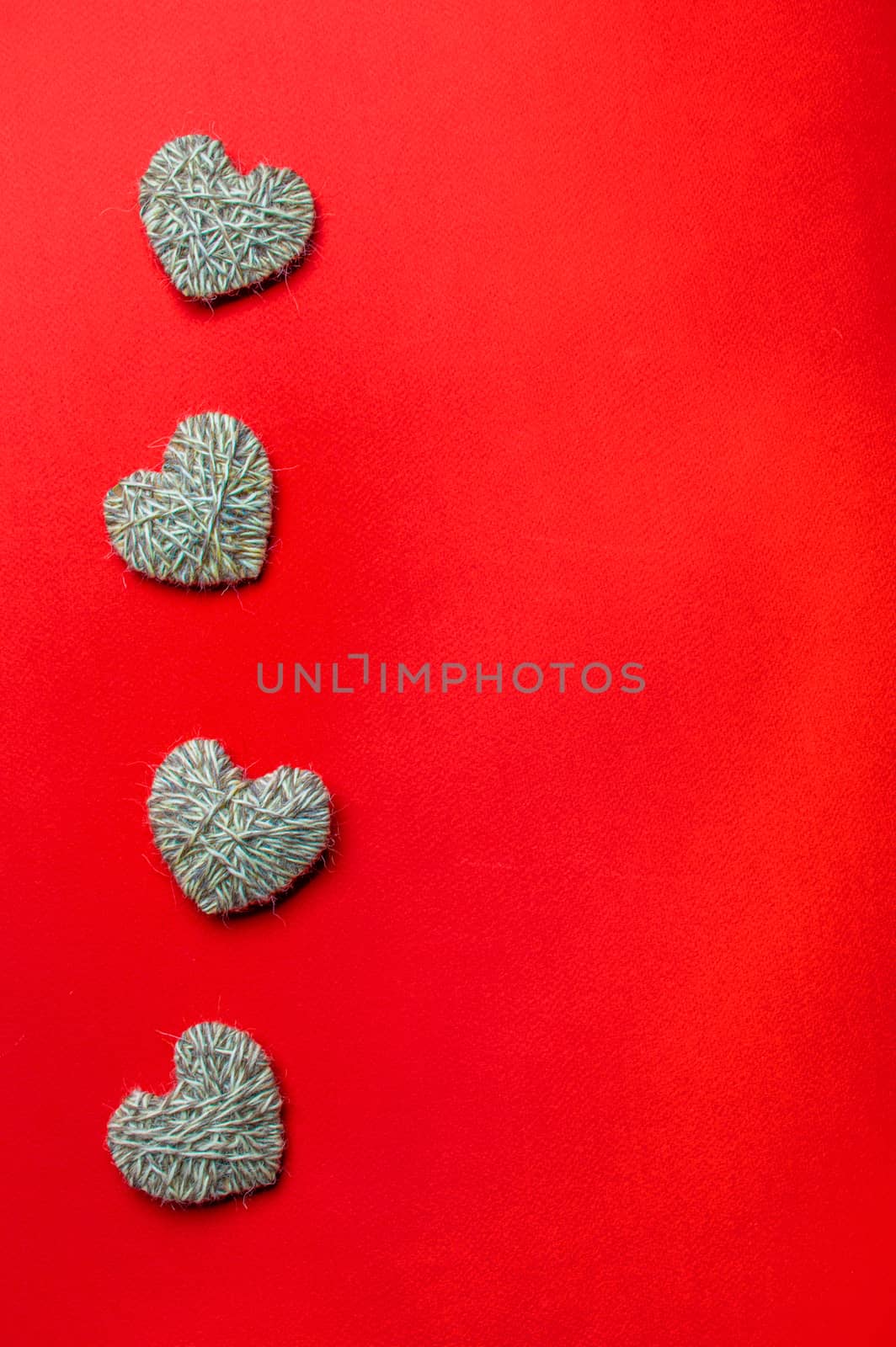 Zero waste, Valentine's Day eco-friendly concept. Hearts with yarn on red background. Copy space for text or design. Top view or flat lay