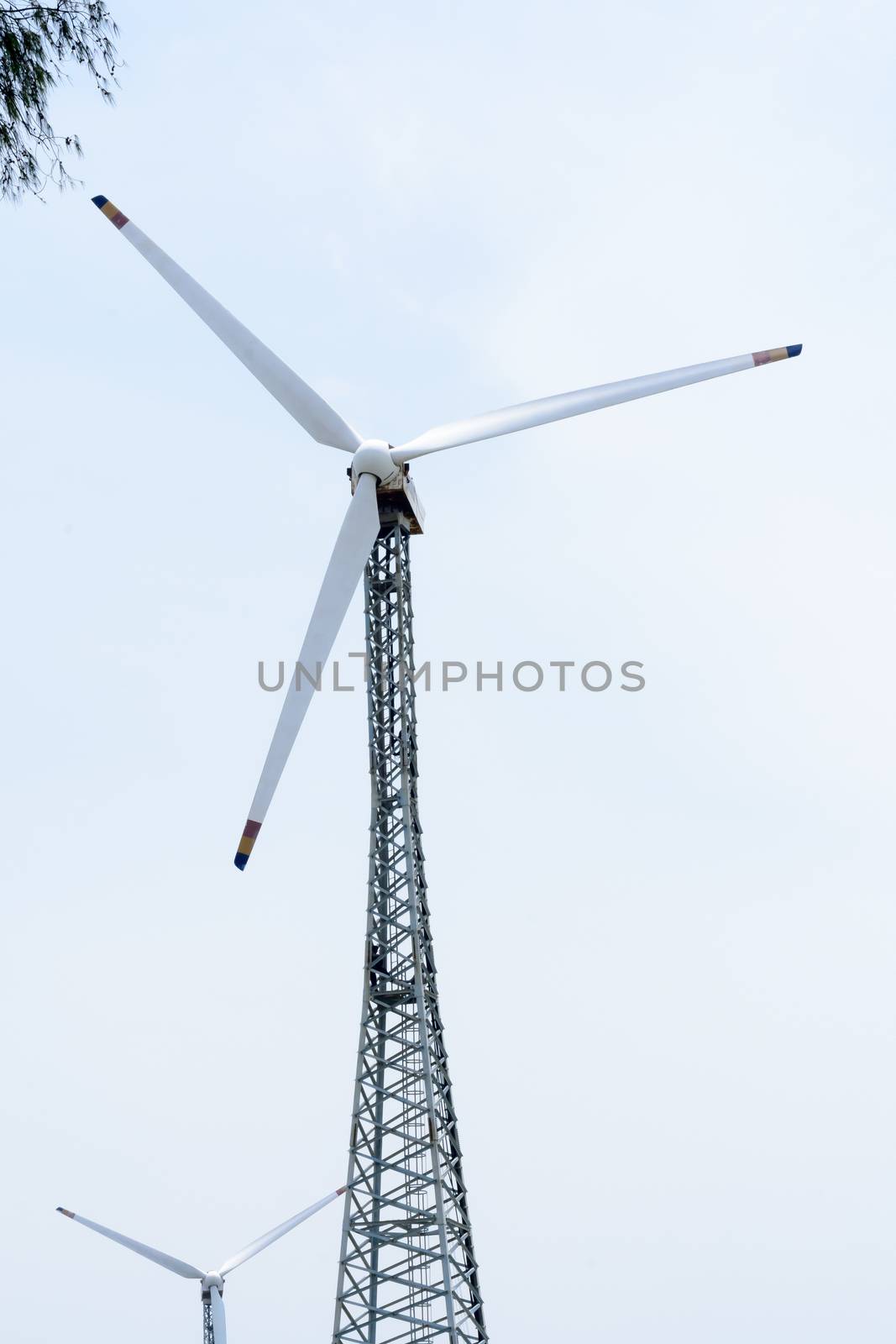 Taller hybrid tower lattice wind turbine build of rolled steel (tubular segmented) install high up 200 feet over land with 100m diameter rotor. Wind turbines widely used in renewable energy resource. In industry like roads, power collection network, substation, meteorology.