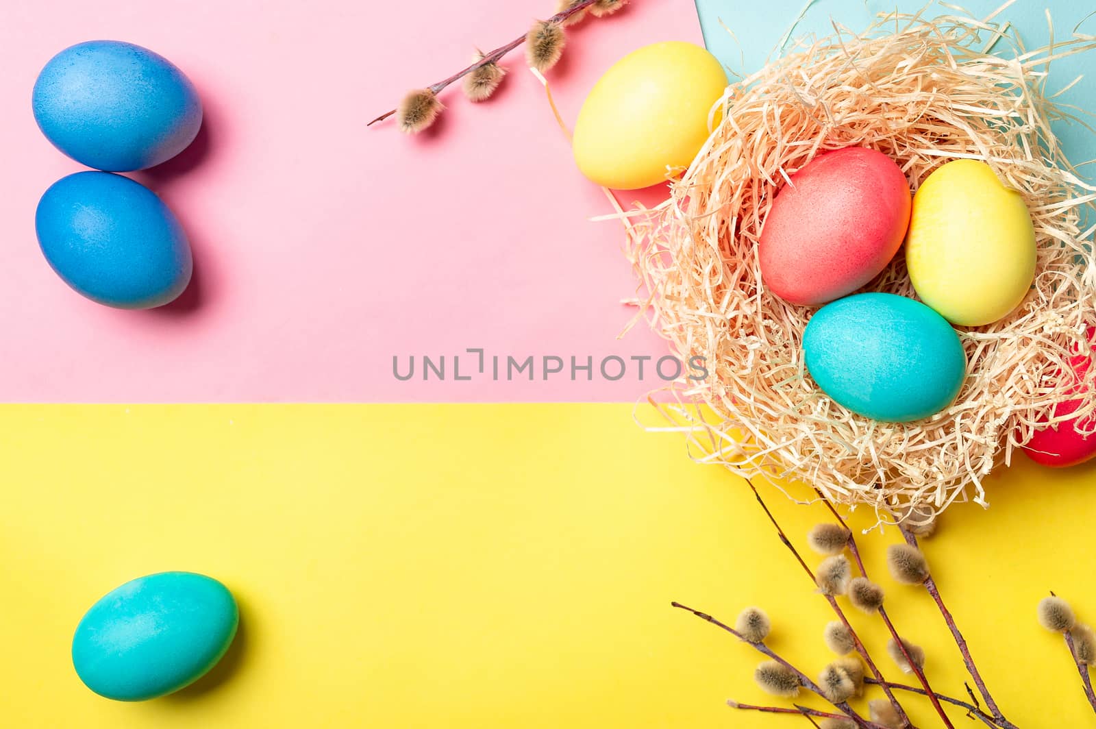 Easter concept. Colorful eggs on bright colorful background with copy space for text. Top down view or flat lay