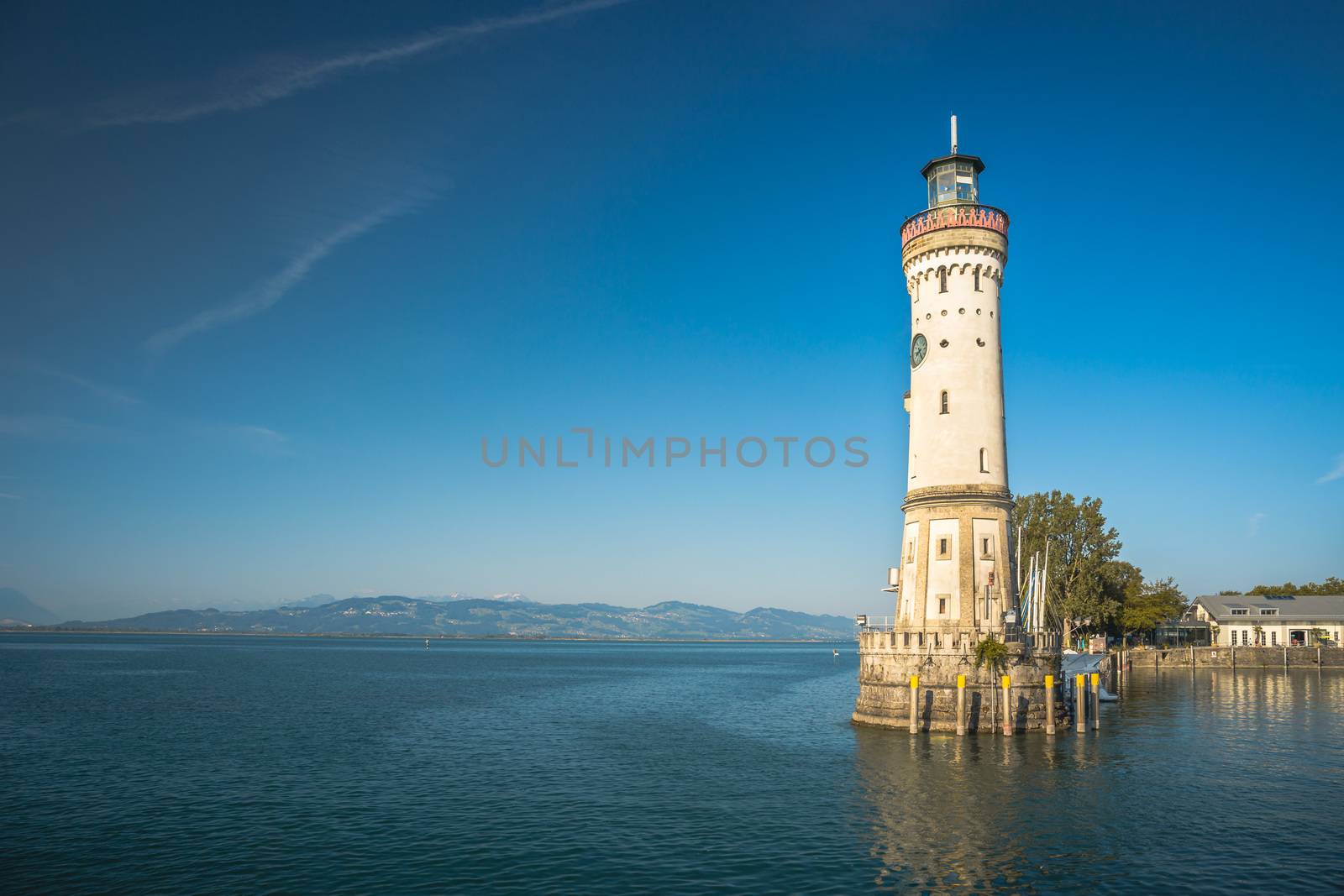 Lighthouse in the harbor of Lindau, Bavaria. A city in Germany, on an island in the middle of Lake Constance. Alps in the background