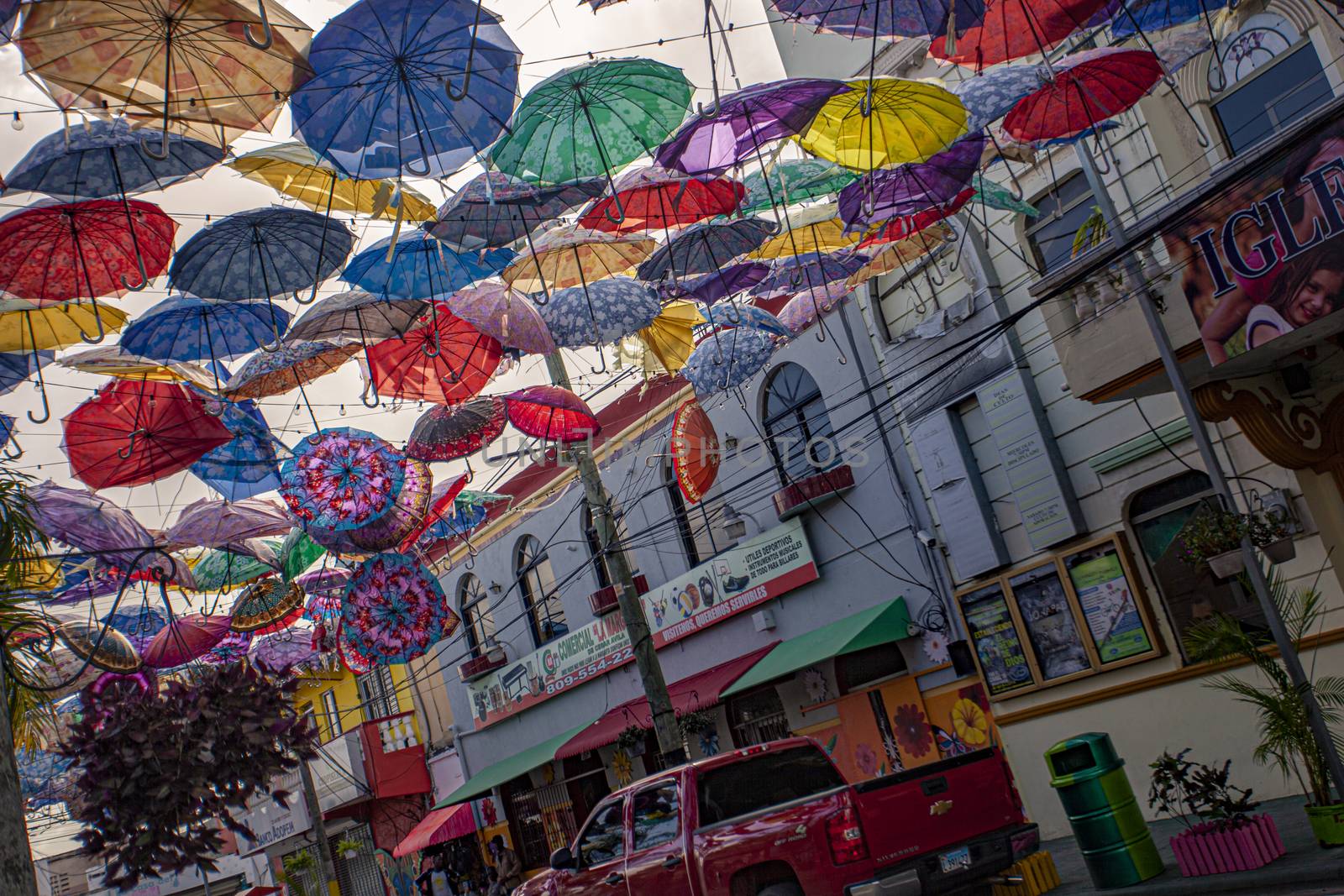 Colored umbrellas suspended in Higuey street 2 by pippocarlot