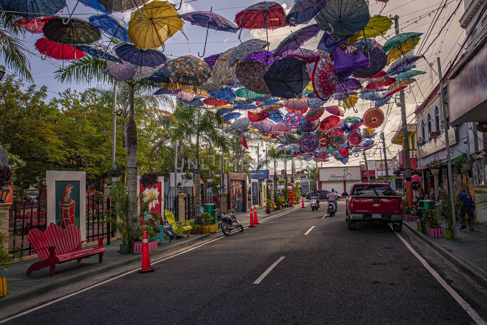 Colored umbrellas suspended in Higuey street by pippocarlot