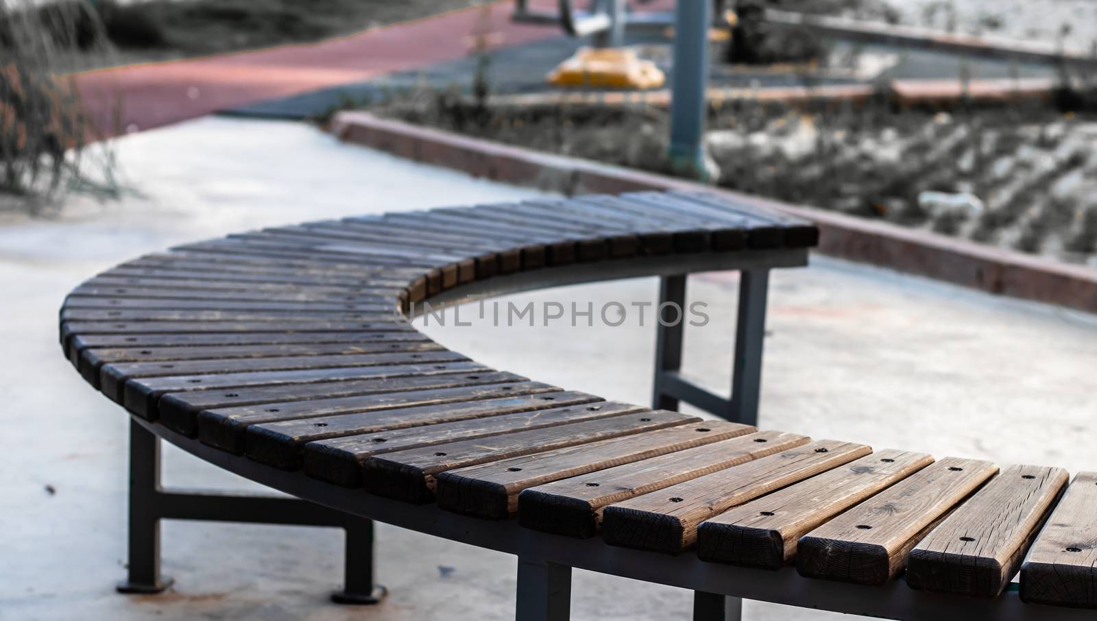 a closeup shoot to rounded shaped brown wooden long chair. photo has taken at aydin/turkey.