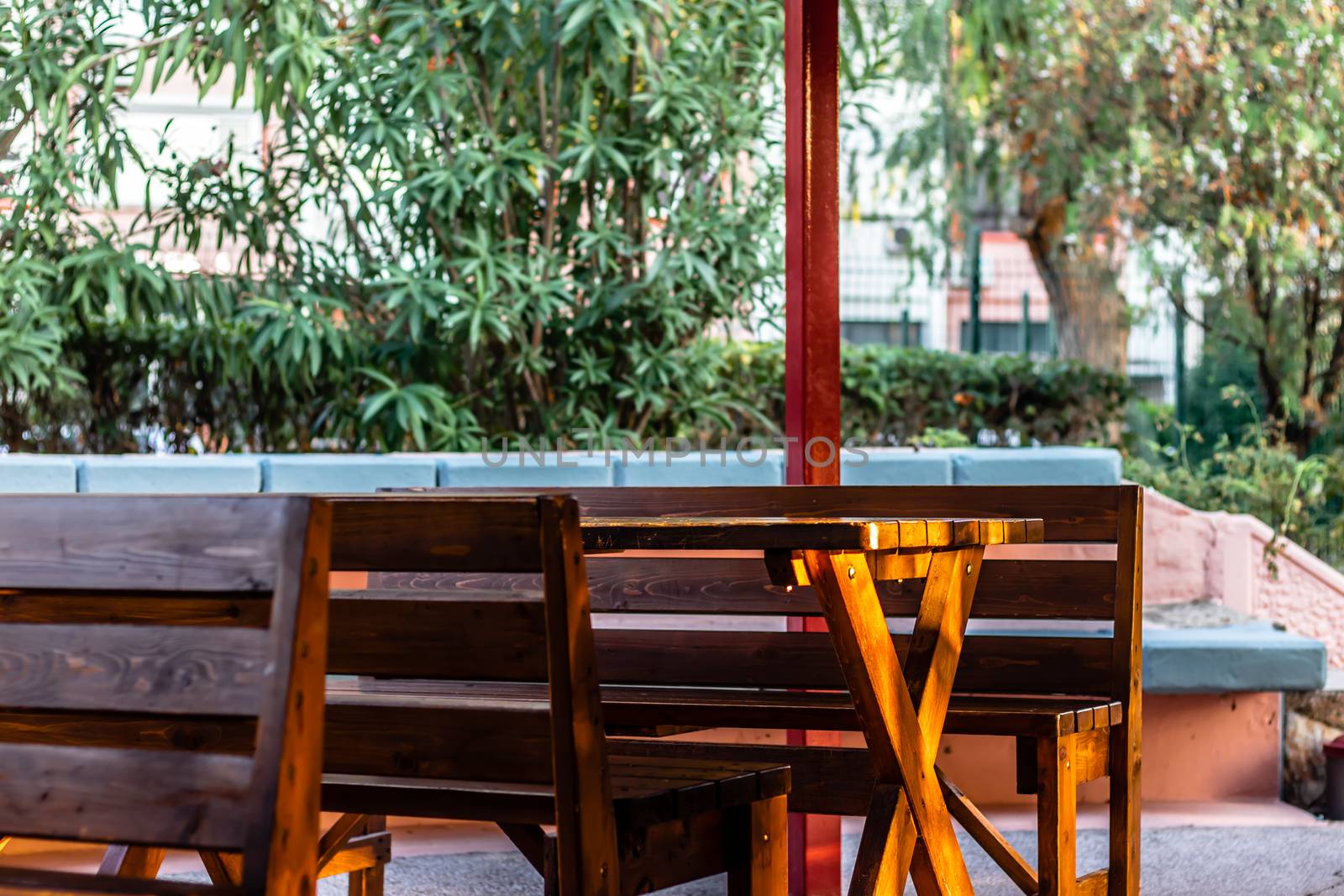 some wooden chairs and table has set like a cafe in a residental area. photo has taken at izmir/turkey.